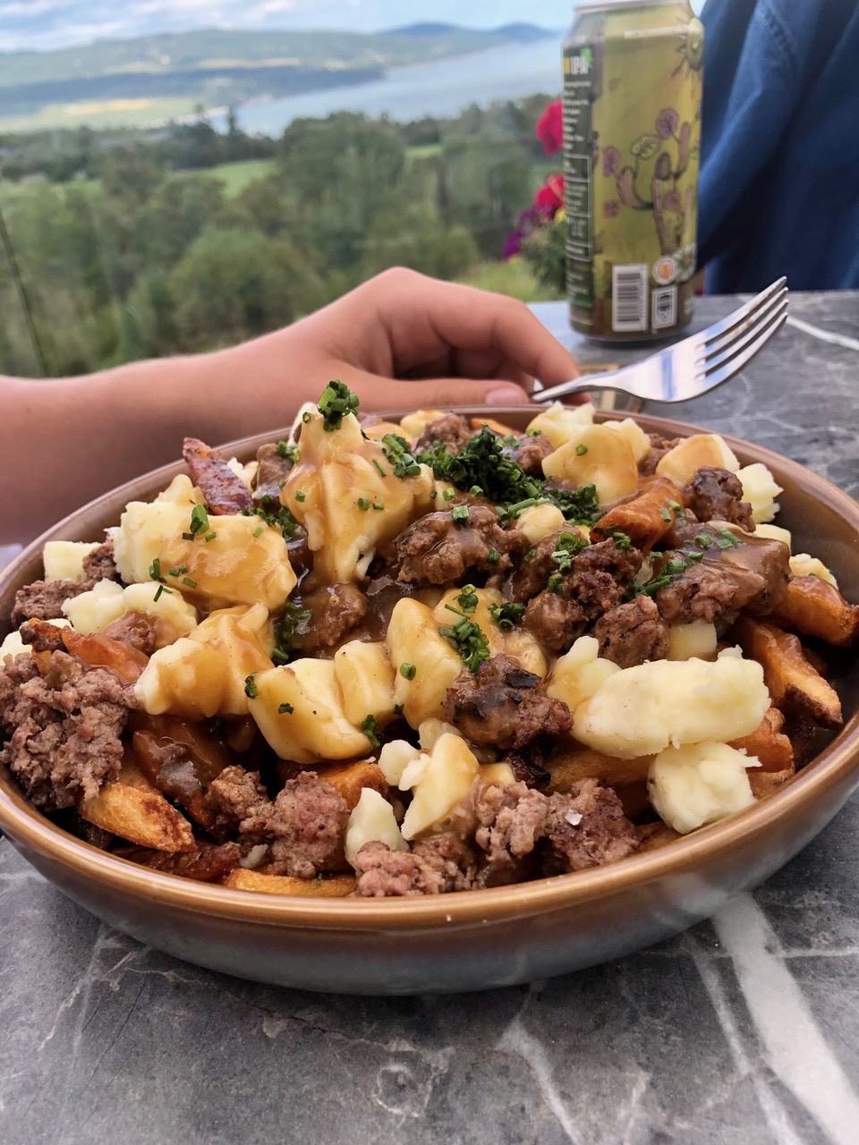 Poutine on the terrace of the Fairmont Manoir Richelieu restaurant on their golf course with most spectacular views